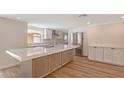 Modern kitchen featuring new stainless steel appliances, a large island, and bright lighting at 1203 Lyric Ln, Sarasota, FL 34242