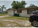 Modest single-story home with a one car garage, and simple landscaping at 14396 Pambar Ave, Port Charlotte, FL 33953