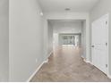 Open-concept foyer flows into the living area showcasing neutral walls and light-colored tile flooring at 15508 High Bell Pl, Bradenton, FL 34212