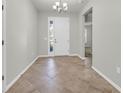 Inviting foyer features neutral walls, a decorative light fixture and light-colored tile flooring at 15508 High Bell Pl, Bradenton, FL 34212