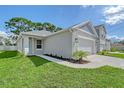 This home has a well-manicured lawn, concrete walkway, and two-car garage at 1643 35Th St, Sarasota, FL 34234
