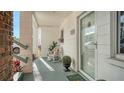 Welcoming front porch with a rocking chair, plants, and a view of the entrance at 1838 Restful Dr # K-1, Bradenton, FL 34207