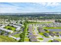 Scenic aerial view of homes in a suburban neighborhood with lush landscaping and a calm pond at 2105 Grand Flora Trl, Bradenton, FL 34208