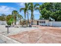 Beautiful single-story home with lush landscaping, palm trees, rock details, and an inviting driveway at 2363 Milford Cir, Sarasota, FL 34239
