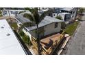 Aerial view of a cozy home with a charming wooden porch, surrounded by tropical landscaping at 2601 Gulf N Dr # B4, Bradenton Beach, FL 34217