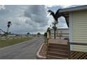 Property with inviting front porch and walkway leading to a scenic community pier nearby at 2601 Gulf N Dr # B4, Bradenton Beach, FL 34217