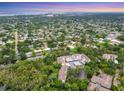 Expansive aerial shot of the condo, showcasing the lush neighborhood and city skyline at 2740 Orchid Oaks Dr # 304, Sarasota, FL 34239
