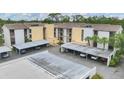 Exterior of the condo with carport parking, showcasing a well-maintained building at 2740 Orchid Oaks Dr # 304, Sarasota, FL 34239