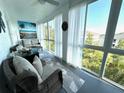 Inviting Florida room with comfortable seating, sheer curtains, and floor to ceiling windows offering plenty of natural light at 3272 Lake Bayshore Dr # 515, Bradenton, FL 34205