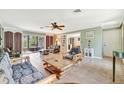 Bright living room featuring tile floors, light green walls, and a ceiling fan at 3428 Mineola Dr, Sarasota, FL 34239
