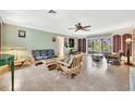 Spacious living room featuring tile floors, light green walls, and bamboo furniture at 3428 Mineola Dr, Sarasota, FL 34239