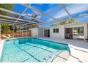 Sparkling screened-in pool with lounge chairs and a spacious deck for outdoor enjoyment at 3975 Coleridge Pl, Sarasota, FL 34241