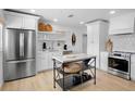 Well-lit kitchen boasts stainless steel appliances, a convenient island, and ample storage space at 404 Bayshore Rd, Nokomis, FL 34275