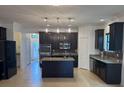 Spacious kitchen featuring dark wood cabinetry, granite countertops, and stainless steel appliances at 4077 River Bank Way, Punta Gorda, FL 33980
