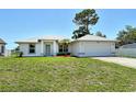 Inviting single-story home with manicured lawn, neutral paint, and an attached two-car garage at 4484 Tortoise Rd, Venice, FL 34293