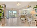 Bright living room featuring tile floors, vaulted ceilings, and a sliding glass door to the lanai at 4484 Tortoise Rd, Venice, FL 34293