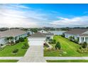 Beautiful single-story home with a two-car garage, positioned with a serene lake backdrop at 4625 Canoe Creek Ave, Parrish, FL 34219