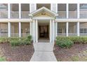 Condo building entrance with stairs and screened in porches on multiple floors at 4802 51St W St # 808, Bradenton, FL 34210