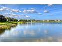 A serene lake view showcases the community's fountain, landscaping, and surrounding homes at 5187 Barnett Cir, Lakewood Ranch, FL 34211