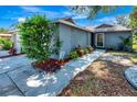 A well-manicured front yard and walkway lead to the entrance of this charming single-story home at 5192 Cedar Hammock Ln, Sarasota, FL 34232