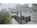 Quaint covered porch with black railing and a cozy bench offer a relaxing outdoor space at 5325 Murdock Ave, Sarasota, FL 34231