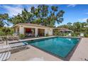 Community pool featuring a covered patio and lounge area for relaxation at 5356 Royal Palm Ave # 5356, Sarasota, FL 34234