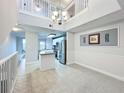 Open concept dining room with tile floors, chandelier, and views of kitchen at 5459 Bentgrass Dr # 2-116, Sarasota, FL 34235