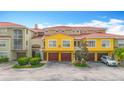 Bright townhome featuring a red tile roof, garage, and well-maintained landscaping at 5459 Bentgrass Dr # 2-116, Sarasota, FL 34235