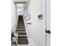 Carpeted staircase with a stair lift offers accessibility and convenience to other floors at 5459 Bentgrass Dr # 2-116, Sarasota, FL 34235