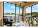 Screened lanai with seating area, offering views of the pond and natural surroundings at 6515 Grand Estuary Trl # 208, Bradenton, FL 34212