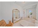 Spacious living room featuring hardwood floors, large mirror, and stylish furnishings at 7279 Kodiak Ln, Sarasota, FL 34240