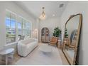 Bright living room with a white sofa, stylish decor, and large windows offering natural light at 7279 Kodiak Ln, Sarasota, FL 34240