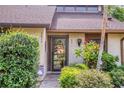 Inviting front door with lush landscaping, flower plants and stylish exterior at 7915 4Th W Ave # 7915, Bradenton, FL 34209