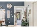 Stylish hallway featuring wood floors, charming decor, and a view of the front entrance at 7915 4Th W Ave # 7915, Bradenton, FL 34209