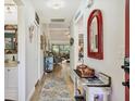 Bright hallway with wood floors, decorated walls, and a glimpse into the living area at 7915 4Th W Ave # 7915, Bradenton, FL 34209