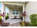 Inviting front porch with seating area, perfect for relaxing and enjoying the outdoors at 8148 Sternway Rd, Sarasota, FL 34240