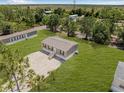 Birds eye view of home with gravel driveway and large manicured lawn at 8426 Sweden Blvd, Punta Gorda, FL 33982