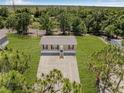 Aerial view of a single-story home on a large lot surrounded by trees at 8426 Sweden Blvd, Punta Gorda, FL 33982