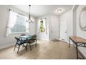 Bright dining area with tile flooring, chandelier, and lots of natural light from large windows at 8437 Nandina Dr, Sarasota, FL 34240