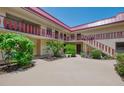 Charming courtyard view with well-maintained landscaping and multi-story buildings at 96 Boundary Blvd # 127, Rotonda West, FL 33947