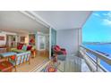 Relaxing balcony with seating and expansive water views, adjacent to the living area at 988 Blvd Of The Arts # 1016, Sarasota, FL 34236