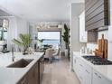 Modern kitchen with stainless steel appliances, sleek countertops, and an adjacent dining area at 1198 Blue Shell Loop, Sarasota, FL 34240
