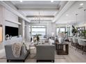 Bright, open living room featuring waterfront views, modern decor, and ample seating at 1198 Blue Shell Loop, Sarasota, FL 34240