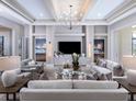 Sophisticated living room showcasing stylish furnishings, a tray ceiling, and a modern aesthetic at 1198 Blue Shell Loop, Sarasota, FL 34240