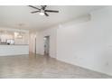 Spacious living room with tile floors, light neutral paint, and view of kitchen and dining area at 12515 Garibaldi Ln, Venice, FL 34293