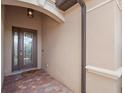 Stylish front entryway with a decorative glass door, brick pavers, a transom window, and a modern light fixture at 14216 Florida Rosemary Dr, Bradenton, FL 34211