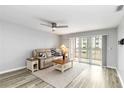 Comfortable living room with a fan, sliding doors to balcony, and a cozy seating area at 150 Harborside Ave # 307, Punta Gorda, FL 33950