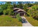 An aerial view of the home showcasing the driveway, garage and surrounding greenery at 1862 Rita St, Sarasota, FL 34231