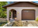 Front exterior showing a one-car garage and covered entryway with arched detailing at 1862 Rita St, Sarasota, FL 34231