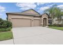Lovely single-story home with a three-car garage, spacious driveway, and well-kept lawn at 18620 Cortes Creek Blvd, Spring Hill, FL 34610